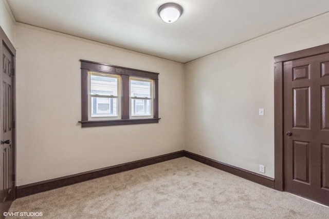 carpeted empty room featuring ornamental molding