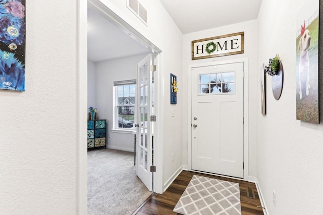 entrance foyer with dark hardwood / wood-style flooring and french doors