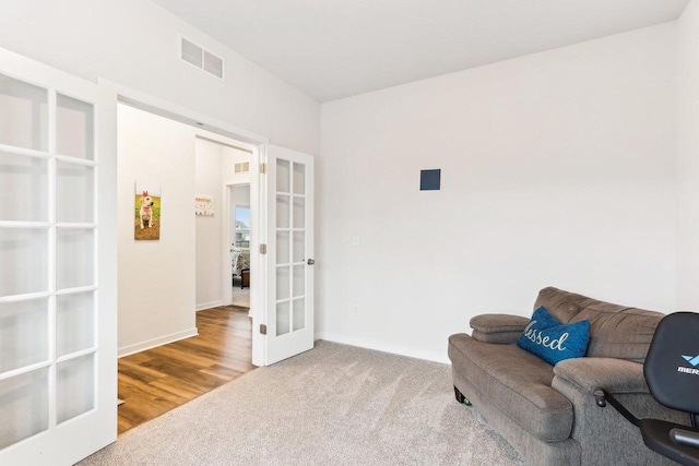 sitting room with french doors and hardwood / wood-style flooring