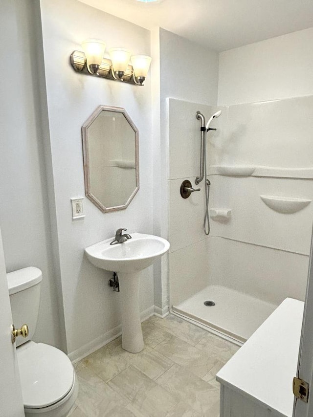 bathroom featuring toilet and walk in shower