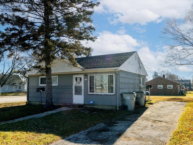 bungalow-style home featuring a front yard