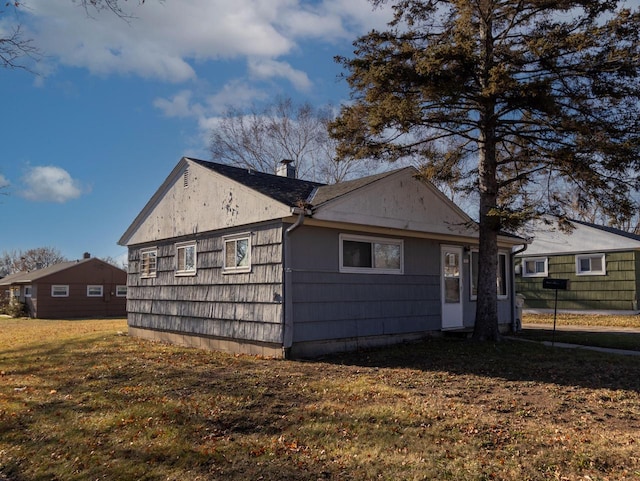 back of property featuring a lawn