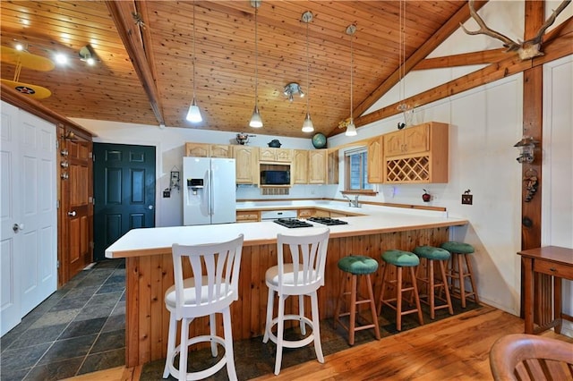 kitchen with kitchen peninsula, light brown cabinetry, white appliances, wooden ceiling, and hanging light fixtures