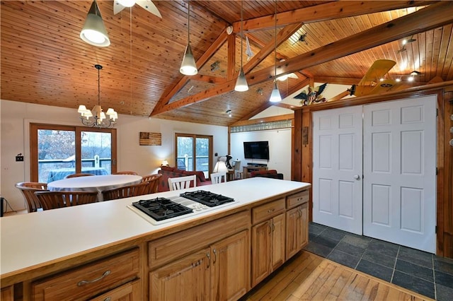 kitchen with hardwood / wood-style floors, white gas stovetop, vaulted ceiling with beams, decorative light fixtures, and wood ceiling