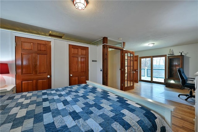 unfurnished bedroom featuring french doors and hardwood / wood-style flooring