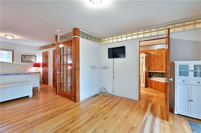 unfurnished bedroom featuring a textured ceiling and light hardwood / wood-style floors