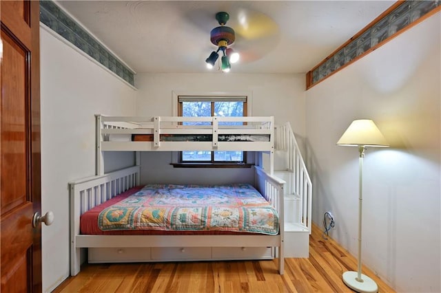 bedroom with ceiling fan and light wood-type flooring