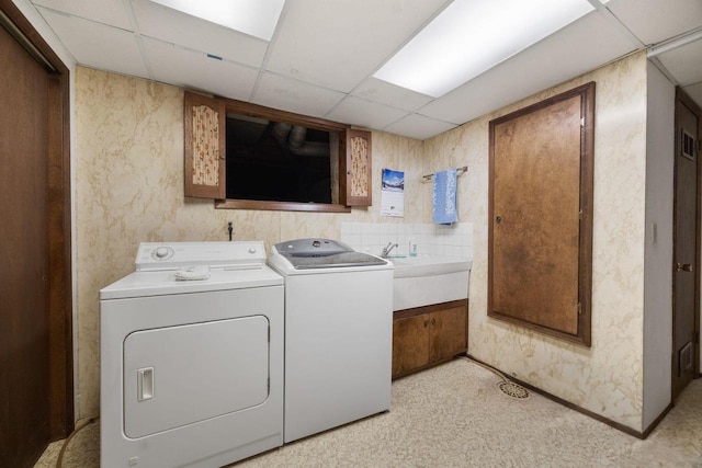 laundry area featuring washer and clothes dryer and sink