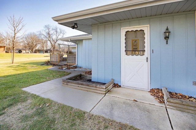 doorway to property featuring a lawn