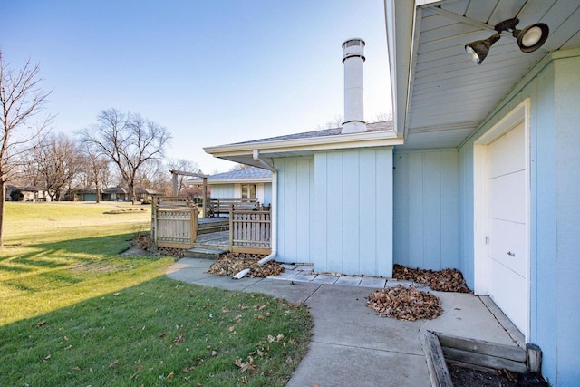 doorway to property featuring ceiling fan and a yard