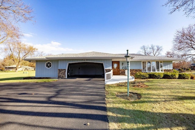 ranch-style house featuring a front lawn and a garage