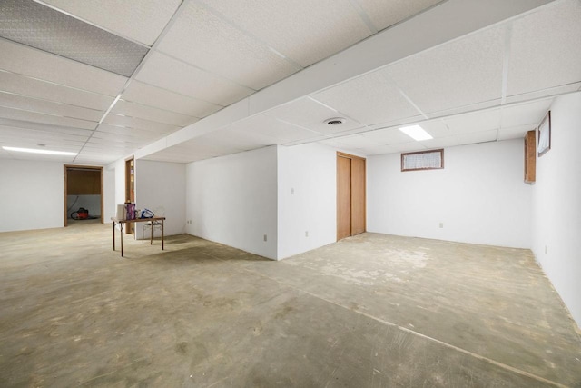 basement with a paneled ceiling