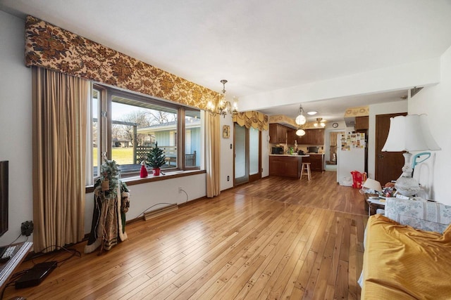 living room with wood-type flooring and a notable chandelier