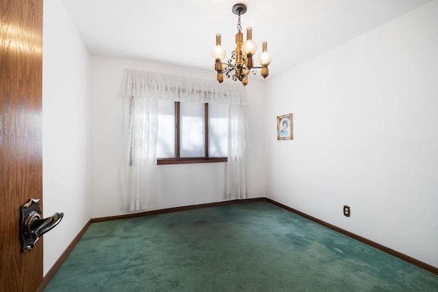 carpeted spare room featuring a chandelier