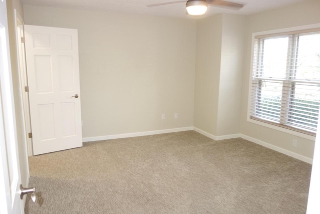 empty room with light carpet and ceiling fan