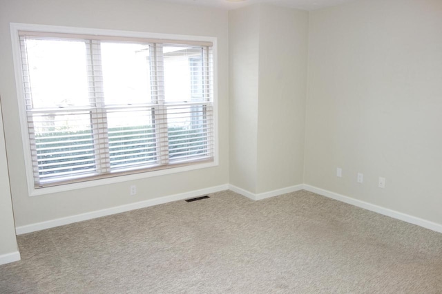 carpeted empty room with plenty of natural light