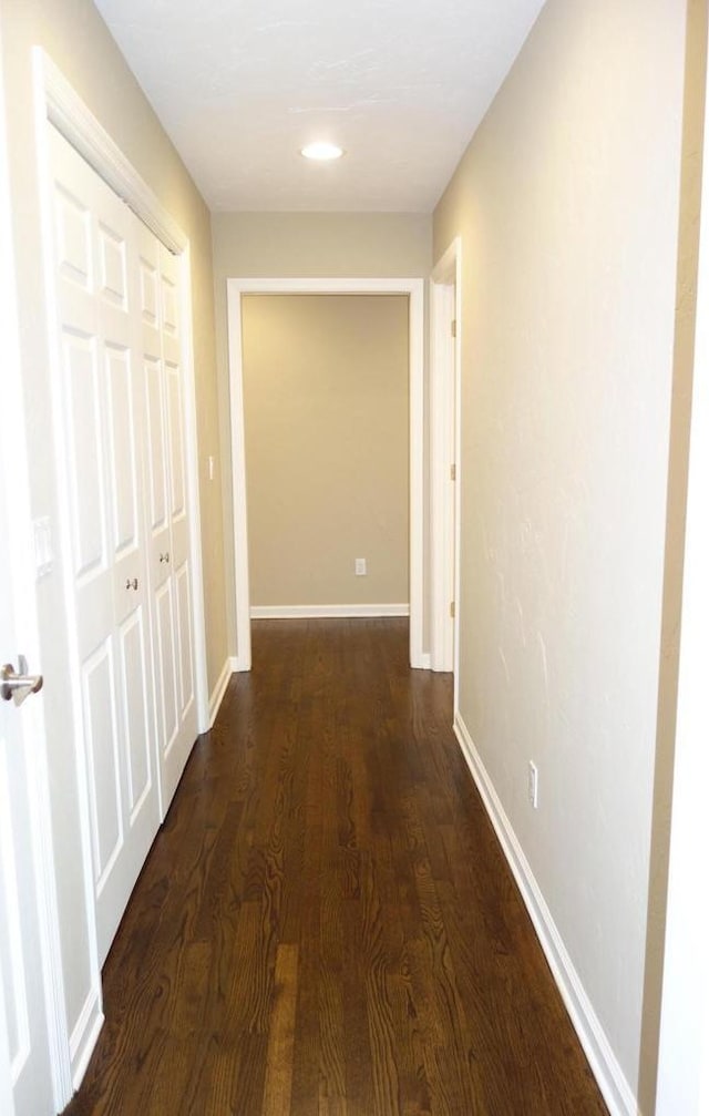 corridor with dark hardwood / wood-style floors