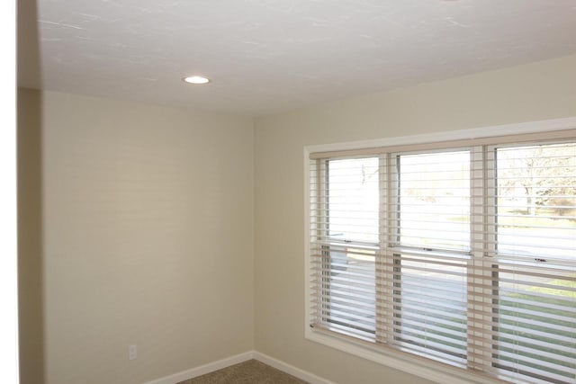 spare room featuring carpet flooring and a healthy amount of sunlight