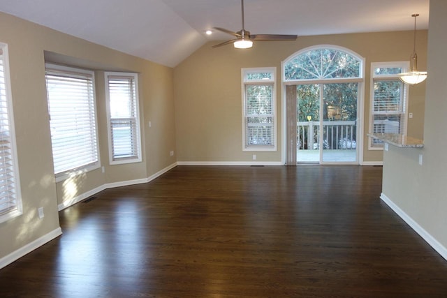 unfurnished living room featuring dark hardwood / wood-style floors, vaulted ceiling, and ceiling fan