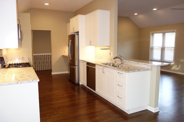 kitchen featuring white cabinets, light stone counters, and sink