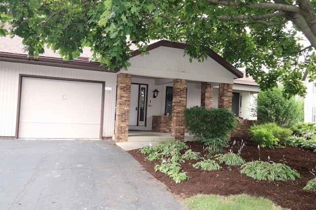 view of front of property with a porch and a garage