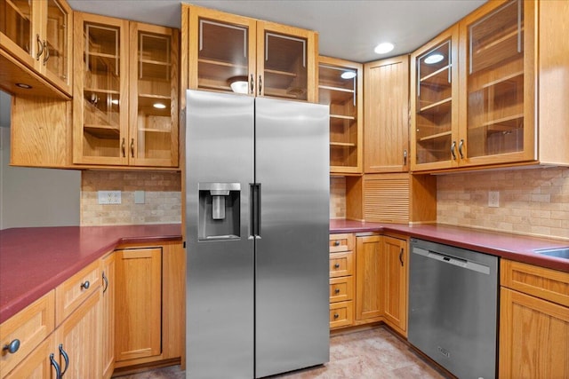 kitchen with decorative backsplash and stainless steel appliances