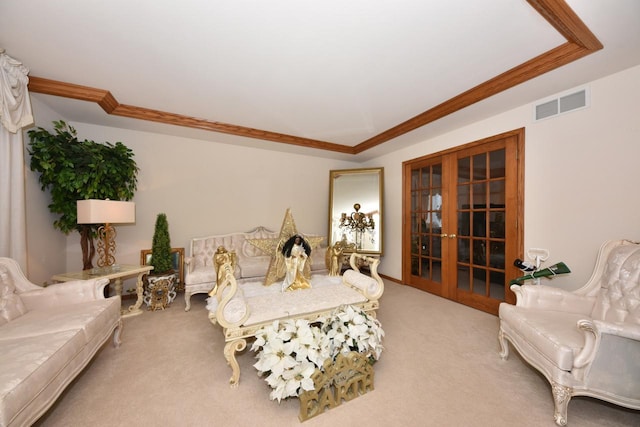 living room with a raised ceiling, light carpet, french doors, and crown molding