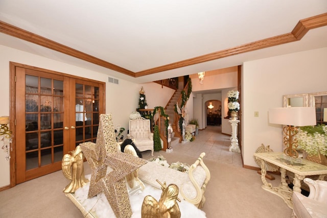 dining room featuring crown molding, light carpet, and french doors