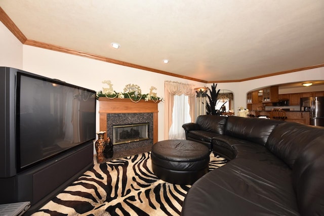 living room featuring a high end fireplace and ornamental molding