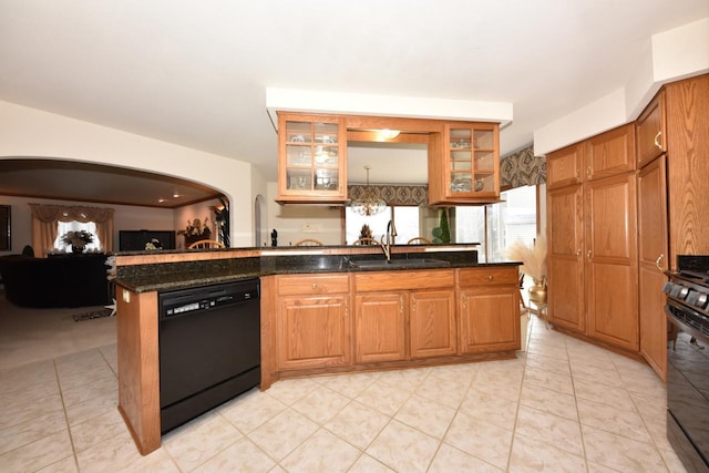 kitchen featuring kitchen peninsula, dark stone counters, sink, black appliances, and light tile patterned flooring