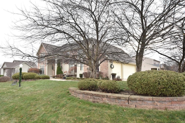 view of front of property with a garage and a front lawn