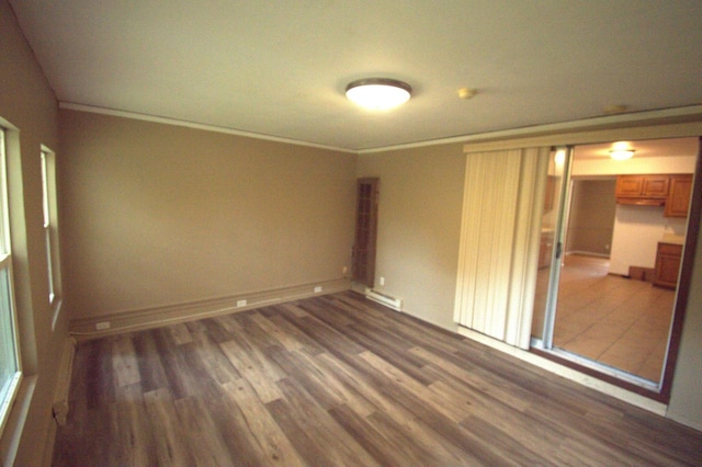 spare room with dark hardwood / wood-style floors and ornamental molding