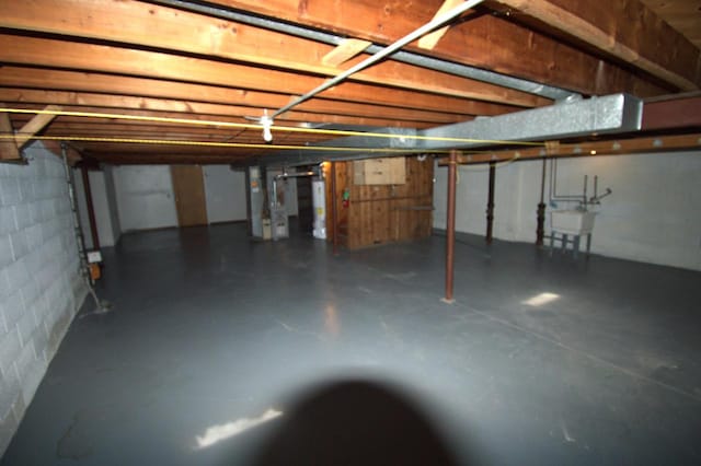 basement with heating unit and sink