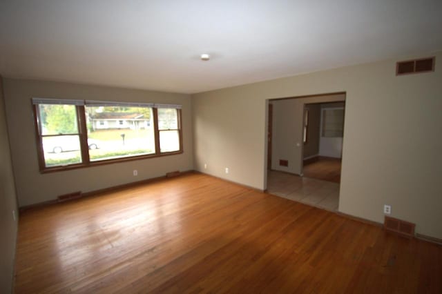 unfurnished room with light hardwood / wood-style floors