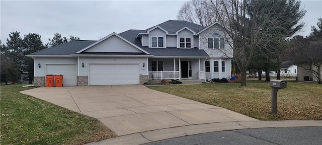 view of front of house with covered porch, a front yard, and a garage