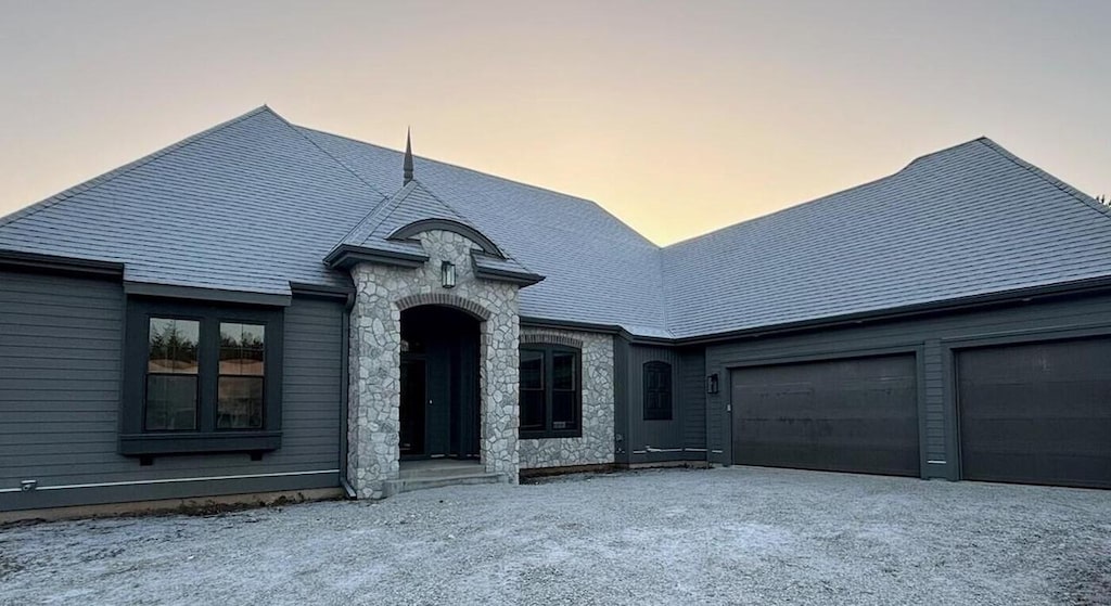 french country inspired facade with a garage