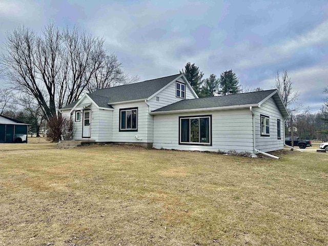 rear view of property with a lawn