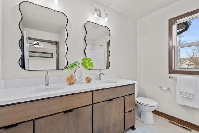 bathroom with toilet, ceiling fan, tile patterned flooring, and vanity