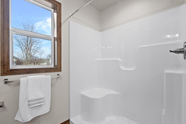 bathroom featuring plenty of natural light and walk in shower