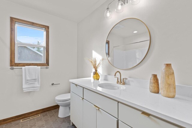 bathroom with a shower, tile patterned floors, toilet, and vanity