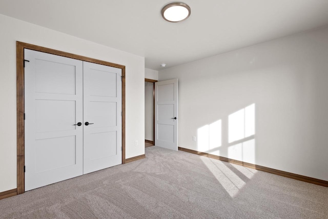 unfurnished bedroom featuring a closet and light carpet