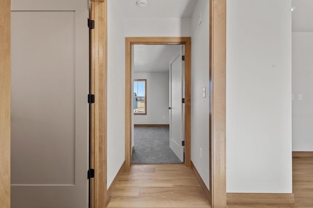 corridor with light hardwood / wood-style floors