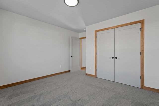 unfurnished bedroom featuring carpet and a closet