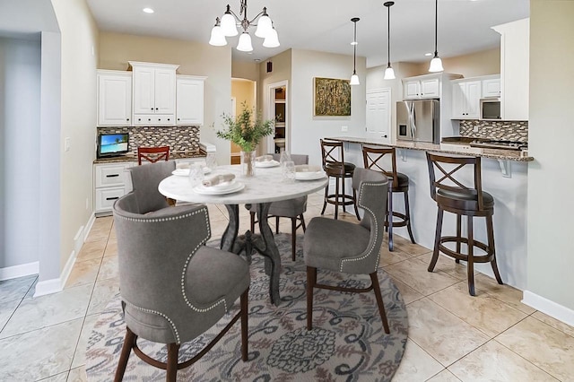 tiled dining area with a chandelier