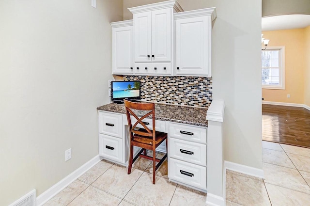 tiled office space featuring built in desk