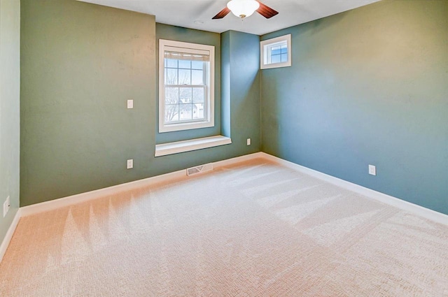 empty room with carpet flooring and ceiling fan