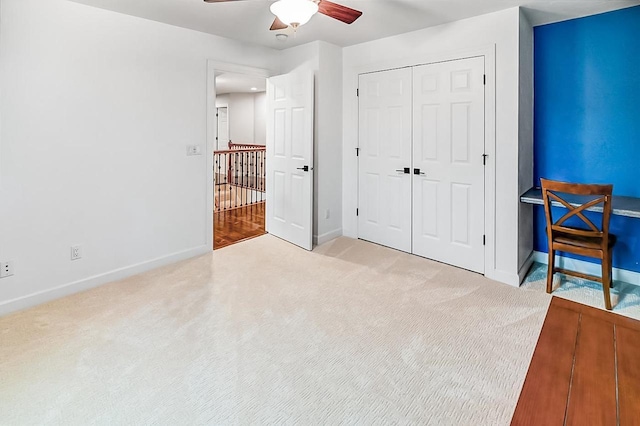 bedroom with light carpet, ceiling fan, and a closet