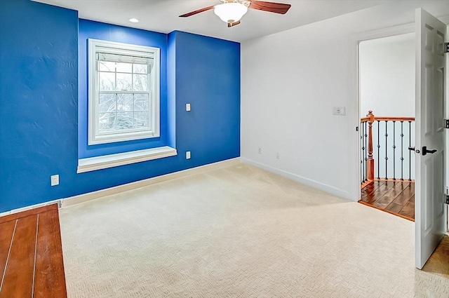 carpeted empty room with ceiling fan