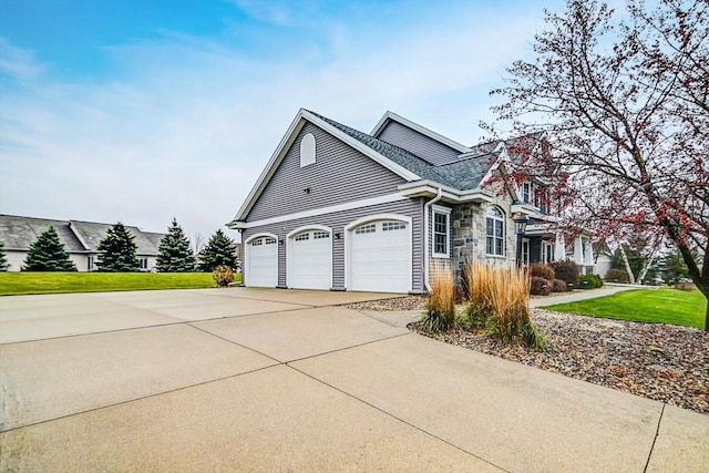 view of home's exterior featuring a garage and a yard