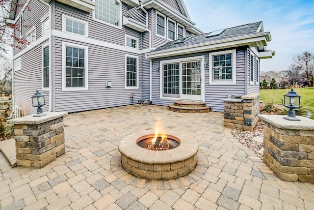 back of property featuring a patio area and an outdoor fire pit